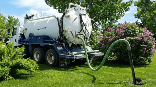 Professional vacuum truck performing residential drainage and septic maintenance in Manchester, NH